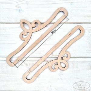 May include: Two unfinished wooden hangers with a decorative crown design. Each hanger measures 20 inches in length.