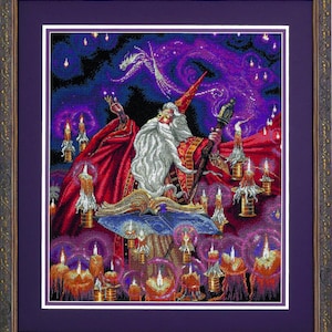 May include: Framed cross-stitch art showing a wizard with a long white beard, red robes, and a pointed hat. The wizard is surrounded by candles and a swirling purple galaxy with a dragon. The frame is dark brown.