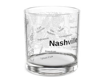 May include: A clear glass tumbler with a map of Nashville printed on the exterior. The city name is prominently displayed in black, with neighborhood names like Germantown and Inglewood visible in a gray font.