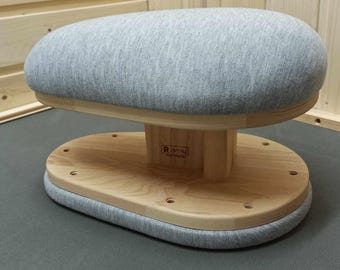 May include: A gray fabric-covered sewing form with a wooden base. The base has a label that reads "R.Ismay".