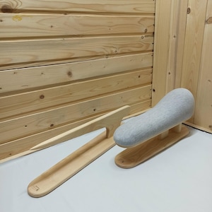 May include: A wooden tailor's clapper with a long, tapered handle and a matching wooden pressing ham base covered in light gray fabric. Both items feature a smooth, natural wood finish and are designed for garment pressing and sewing tasks.