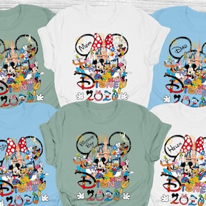 May include: Assorted-color Disney-themed t-shirts. Each shirt features a Disney character graphic with the word "Disney" and the year "2020". Some shirts have text like "Mom", "Dad", "Brother", "Big Sis", "Birthday Boy", and "Helen".