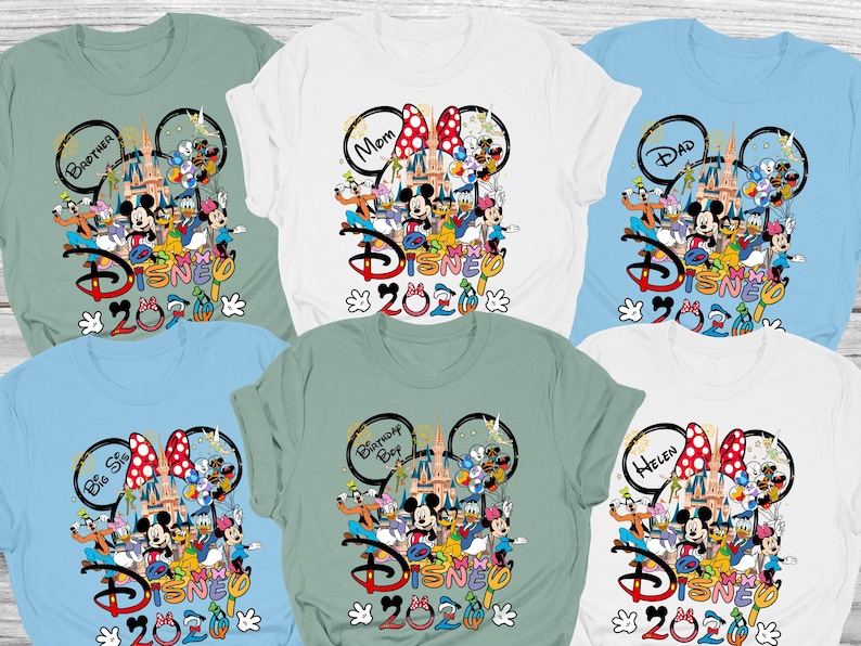 May include: Assorted-color Disney-themed t-shirts. Each shirt features a Disney character graphic with the word "Disney" and the year "2020". Some shirts have text like "Mom", "Dad", "Brother", "Big Sis", "Birthday Boy", and "Helen".