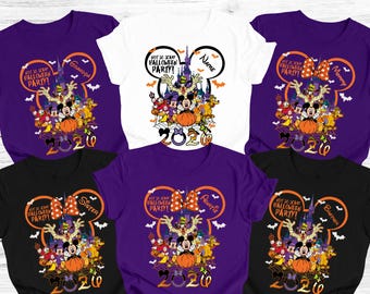 May include: A collection of Halloween-themed t-shirts in various colors, including purple, black, and white. Each shirt features a graphic of Disney characters, a pumpkin, and the text "Not So Scary Halloween Party!" with the year 2020.