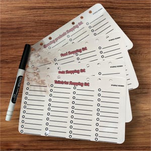 May include: Four white shopping list pages with black lines and circles. The pages are stacked on top of each other. The top page has the text "Cleaning products shopping list" in red. The second page has the text "Food shopping list" in red. The third page has the text "Pets shopping list" in red. The fourth page has the text "Toiletries shopping list" in red.