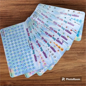 May include: A set of colourful coin saving trackers with a holographic finish. Each tracker features a different coin denomination, from 1p to £2, and includes the total amount saved. The trackers are designed to help you save money and track your progress.