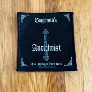 May include: Black square patch with white gothic text reading "Gorgoroth's Antichrist" and a grey inverted cross. The patch also features "True Norwegian Black Metal" and "©2004 NUCLEAR BLAST" in white.