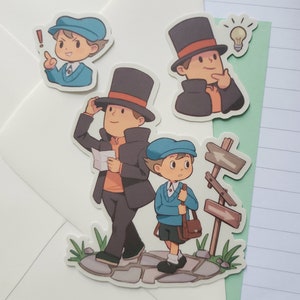 May include: Four cartoon stickers featuring characters from the video game Professor Layton. The stickers are on a white background. The stickers feature a boy in a blue hat and a blue jacket, a boy in a blue hat and a blue sweater, a man in a black coat and a top hat, and a man in a black coat and a top hat thinking with a lightbulb above his head.