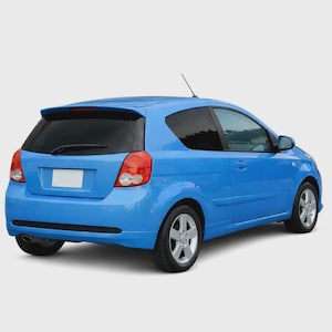 May include: A bright blue three-door hatchback car viewed from the rear three-quarter angle. The vehicle features a rear spoiler, a single exhaust pipe on the lower left, silver alloy wheels, and a blank white number plate area on the boot.
