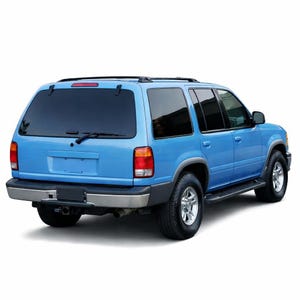 May include: A light blue SUV viewed from the rear three-quarter angle, featuring tinted windows, a black roof rack, a silver rear bumper, and black trim along the wheel arches. The vehicle has silver wheels and a rear windscreen wiper.