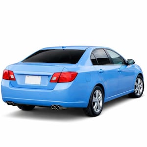 May include: A light blue saloon car viewed from the rear three-quarter angle, featuring dark tinted windows, silver alloy wheels, a blank white number plate area, and a dual exhaust system with two chrome-tipped pipes on each side of the rear bumper.