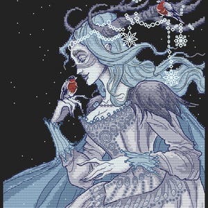 May include: Cross-stitch design of a woman with flowing blue hair and a decorative dress, interacting with a small red-breasted bird. The artwork features snowflake and star details against a black background. The artist's name, BananiStitchery, is at the bottom.