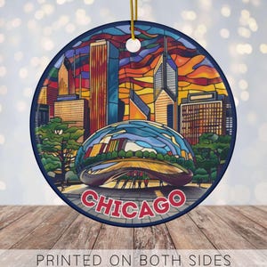May include: Round ornament featuring a colorful Chicago skyline design. The ornament includes the city's name in red and a depiction of the Cloud Gate sculpture. The text "PRINTED ON BOTH SIDES" is at the bottom.
