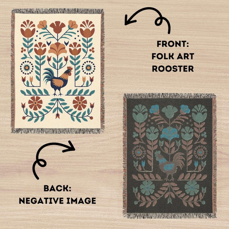 May include: A reversible woven throw blanket with a folk art rooster design. The front has a cream background with a rooster, flowers, and foliage in teal, brown, and orange. The back is a negative image on a dark grey background.