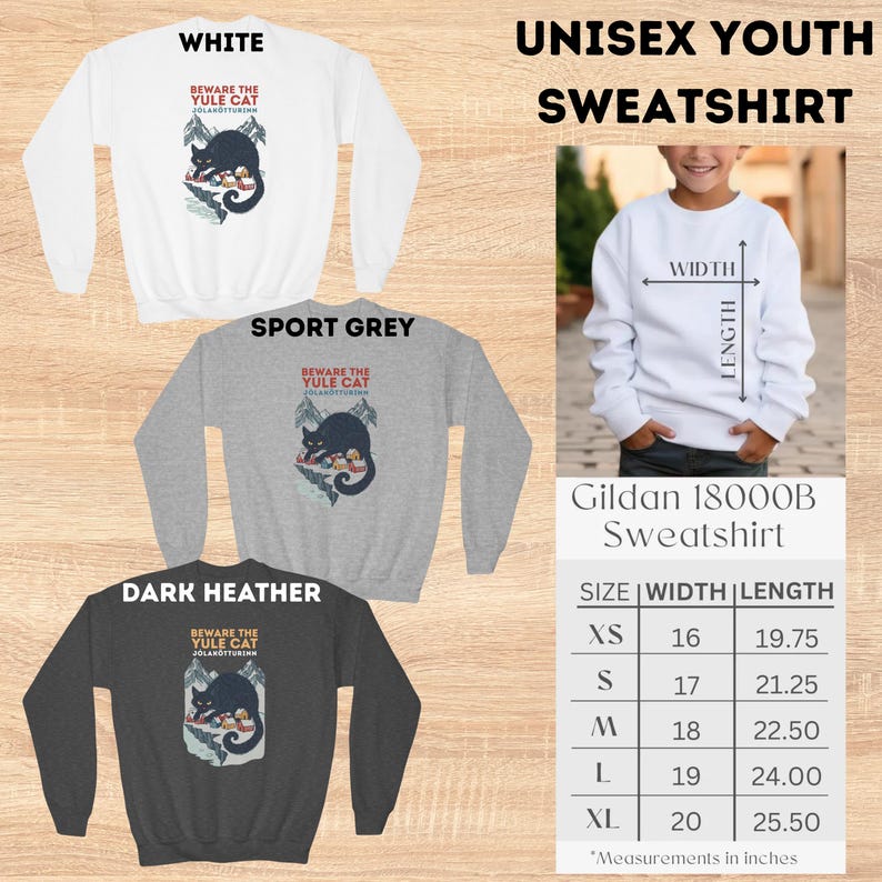 May include: A white, sport grey, and dark heather youth sweatshirt featuring a graphic of a black cat over a snowy village with the text Beware The Yule Cat J&oacute;lak&ouml;tturinn. A size chart displays width and length measurements in inches.