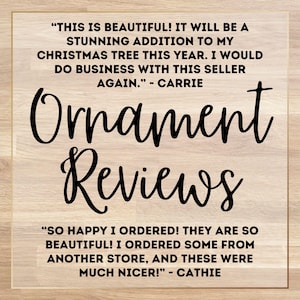 May include: A wooden background with the words "Ornament Reviews" in large, black, cursive font. Above and below are customer reviews praising the product's beauty and quality, mentioning Christmas trees and a seller.