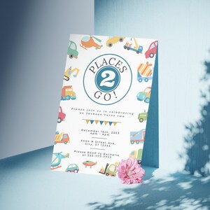 May include: A colorful invitation with a blue circle and the text "Places 2 Go!" surrounded by illustrations of vehicles. The invitation is for a birthday party for Jackson turning two years old. The party is on December 16th, 2023 from 4pm to 6pm at 4444 N Street Ave, City, ST 12345. Please RSVP to Rachelle at 333-777-7777.