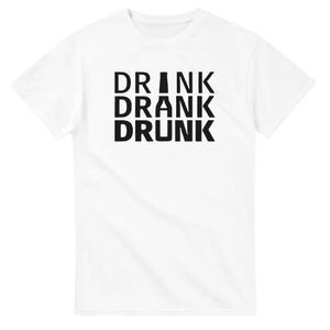 Könnte beinhalten: Weißes T-Shirt mit den Worten "DRINK DRANK DRUNK" in fetten, schwarzen Großbuchstaben. Der Text ist vertikal gestapelt, wobei jedes Wort zentriert ist. Das Shirt ist aus einem weichen Material.