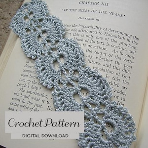 May include: A handmade, light gray crochet bookmark with an openwork design, resting on the pages of a book. The bookmark features a delicate, lacy pattern. Text on the image reads "Crochet Pattern" and "Digital Download".