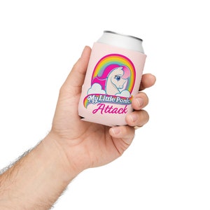 May include: Pink can cooler with a rainbow and a white unicorn with a pink mane and tail. The text "My Little Panic Attack" is printed on the cooler.