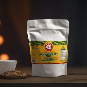 May include: A white bag of "Jerk Batter Fry Mild" masa harina, with a yellow and green label. A small white bowl and a wooden plate with seeds are in the foreground. The background is blurred with warm tones.