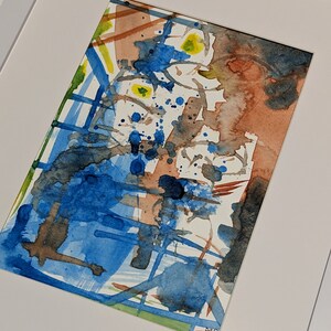 Puede incluir: Pintura abstracta de acuarela en tonos de azul, marr&oacute;n y amarillo. La pintura presenta una variedad de formas y l&iacute;neas, creando una composici&oacute;n din&aacute;mica y en&eacute;rgica.