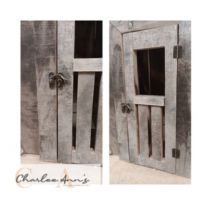 May include: Two wooden doors with a rustic, weathered finish. Each door has a small window and a metal latch. The doors are closed and have a distressed look.