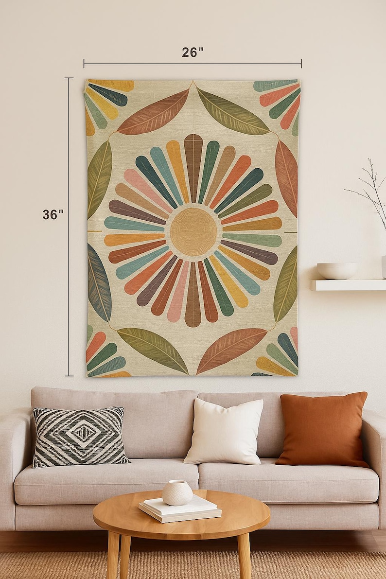 May include: A decorative wall tapestry featuring a large, colorful floral design. The tapestry is 26 inches wide and 36 inches long. The design includes a central sunburst pattern with radiating stripes in various colors, surrounded by leaf-shaped elements.