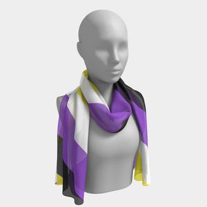 May include: A scarf draped on a mannequin. The scarf features a geometric design with blocks of white, yellow, purple, and black. The scarf is made of a lightweight material and is designed to be worn around the neck.