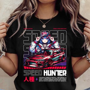 May include: Black t-shirt featuring a graphic of an anime girl wearing a red and blue jacket and a red baseball cap. The girl is standing in front of a red sports car with the words "Speed Hunter" and "人種" printed on the shirt.