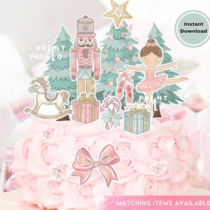 May include: A pink cake decorated with Christmas-themed cutouts, including a nutcracker, ballerina, Christmas trees, and gift boxes. The cake is topped with a large pink bow and the text "Matching Items Available".