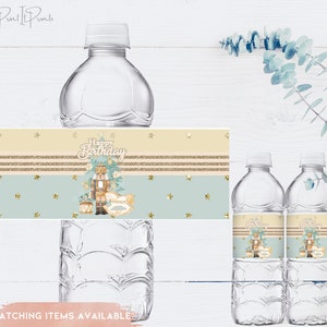 May include: Water bottle labels with a Nutcracker theme. The labels are beige with gold glitter stripes and a light blue background. The labels feature a Nutcracker illustration with the text "Happy Birthday".