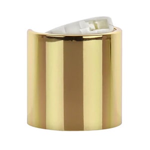 Puede incluir: Tapa de botella de plástico de color dorado con un forro de plástico blanco.