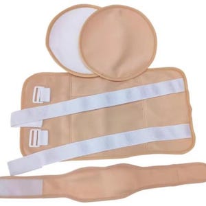 May include: A beige postpartum support belt set. The set includes a rectangular belt with white straps and buckles, two round pads, and a smaller belt with a Velcro closure. The items are arranged on a white background.