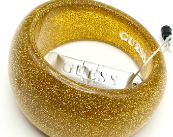 Pulsera rígida gruesa asimétrica de lucita dorada con purpurina estilo años 80 de GUESS