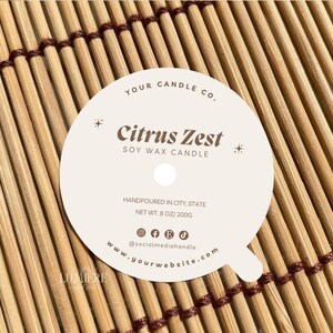 May include: White round candle label with the text "YOUR CANDLE CO." and "Citrus Zest SOY WAX CANDLE" in brown text. The label also includes the text "HANDPOURED IN CITY, STATE NET WT. 8 OZ/200G @socialmediahandle www.yourwebsite.com" in smaller brown text.