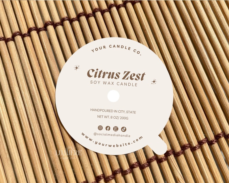 May include: White round candle label with the text "YOUR CANDLE CO." and "Citrus Zest SOY WAX CANDLE" in brown text. The label also includes the text "HANDPOURED IN CITY, STATE NET WT. 8 OZ/200G @socialmediahandle www.yourwebsite.com" in smaller brown text.