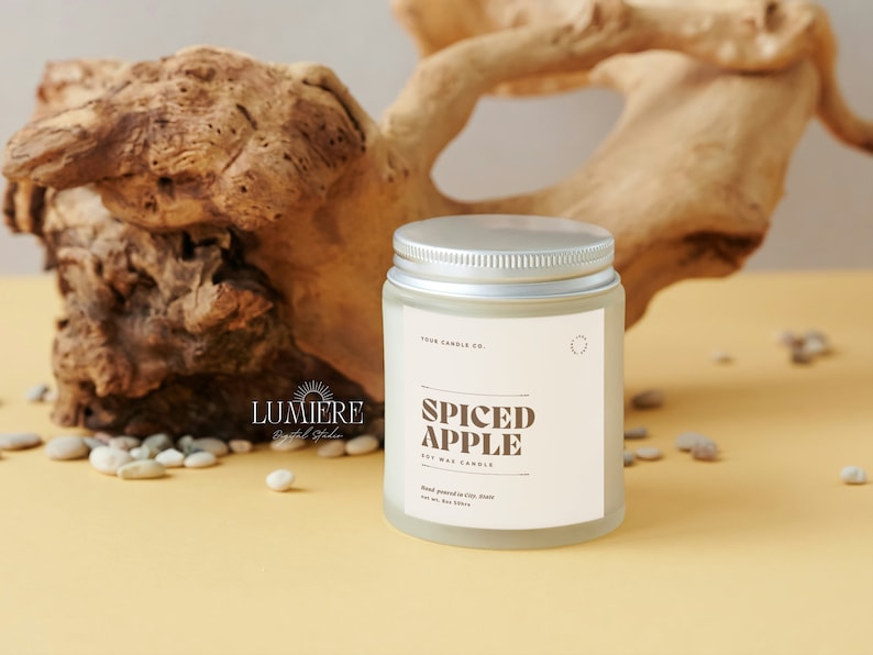 May include: A frosted glass jar candle with a silver lid. The label reads "Four Candle Co." and "Spiced Apple Soy Wax Candle".