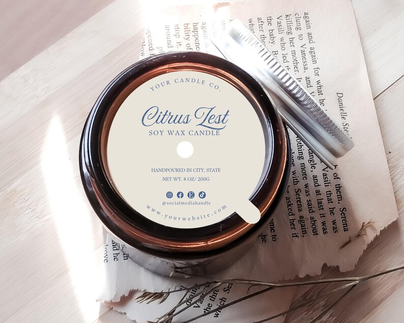 May include: A brown glass candle jar with a white label that reads "Citrus Test Soy Wax Candle". The label also includes the company name, website, and social media handles. The candle is hand-poured and weighs 8 ounces or 200 grams.