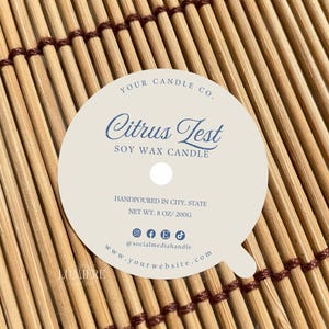 May include: White round candle label with a blue text that reads "YOUR CANDLE CO. Citrus Test SOY WAX CANDLE HANDPOURED IN CITY, STATE NET WT. 8 OZ/200G @socialmediahandie www.yourwebsite.com".