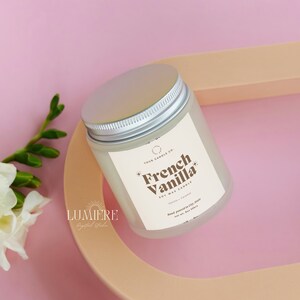 May include: A white soy wax candle with a silver lid. The label reads "Four Candle Co. French Vanilla Soy Wax Candle".
