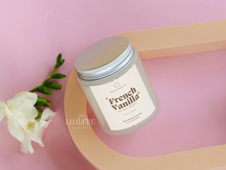 May include: A white soy wax candle with a silver lid. The label reads "Four Candle Co. French Vanilla Soy Wax Candle".