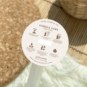 May include: A white round sticker with brown text and icons. The sticker has instructions for candle care, including burning time, wick trimming, and safety precautions. The text reads "Your Candle Co. Candle Care Instructions" and "www.yourwebsite.com".