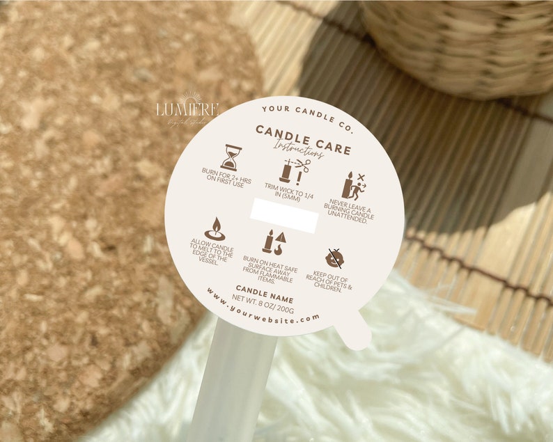 May include: A white round sticker with brown text and icons. The sticker has instructions for candle care, including burning time, wick trimming, and safety precautions. The text reads "Your Candle Co. Candle Care Instructions" and "www.yourwebsite.com".