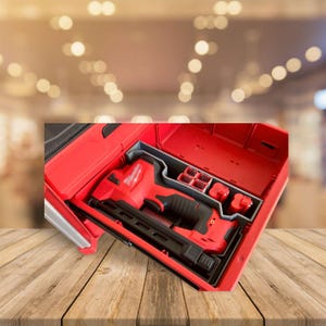May include: A red tool box with a red and black cordless nail gun inside. The tool box has a gray foam insert with compartments for the nail gun and battery.
