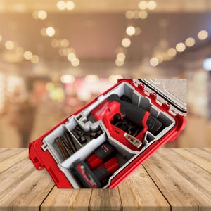 May include: A red and black tool case with a drill, batteries, and bits. The case is open and the drill is visible. The case has a clear plastic lid.