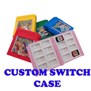 May include: A pink custom Switch game case is open, revealing slots for game cartridges. Various colored Pokemon game cartridges are scattered around the case. The text "CUSTOM SWITCH CASE" is displayed in blue.