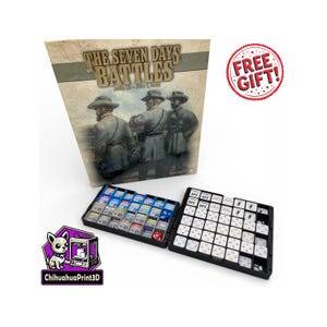 May include: A board game box titled "The Seven Days Battles" with illustrations of soldiers. Two black trays with game pieces are in front of the box. A "Free Gift!" sticker and a ChihuahuaPrint3D logo are also visible.