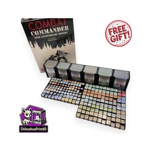 May include: Combat Commander 20th Anniversary Edition board game box set. The box features the game title and a forest scene with a soldier. Includes game cards and game pieces. A "FREE GIFT!" sticker is also visible.