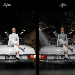 May include: A woman wearing sunglasses and a light blue jumper sits on the back of a white vintage car. The car has a number plate that reads "01 999". The car is parked in a dark, industrial setting.